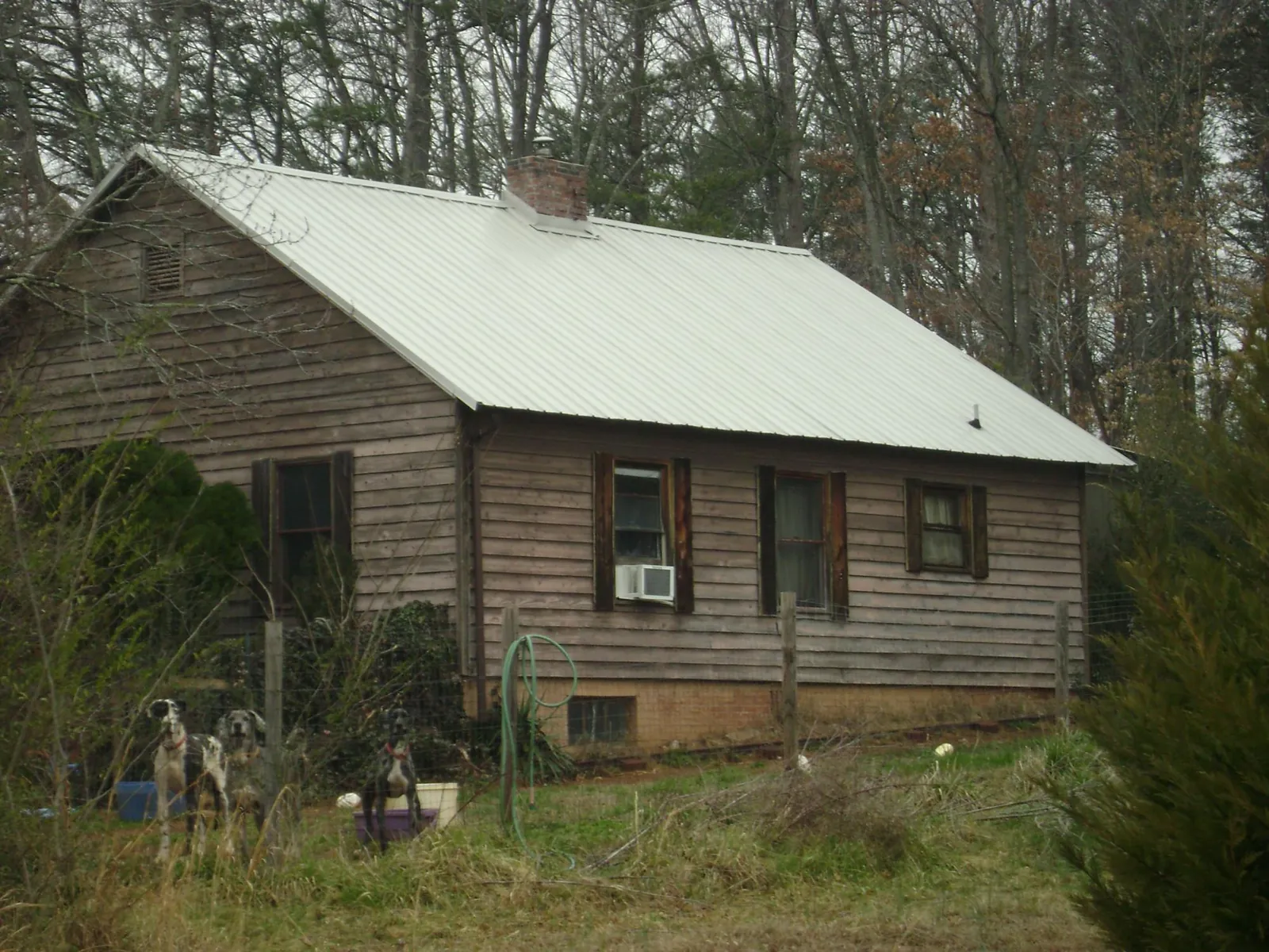 White metal roof on an old wood sided farmhouse in Pocono Pines